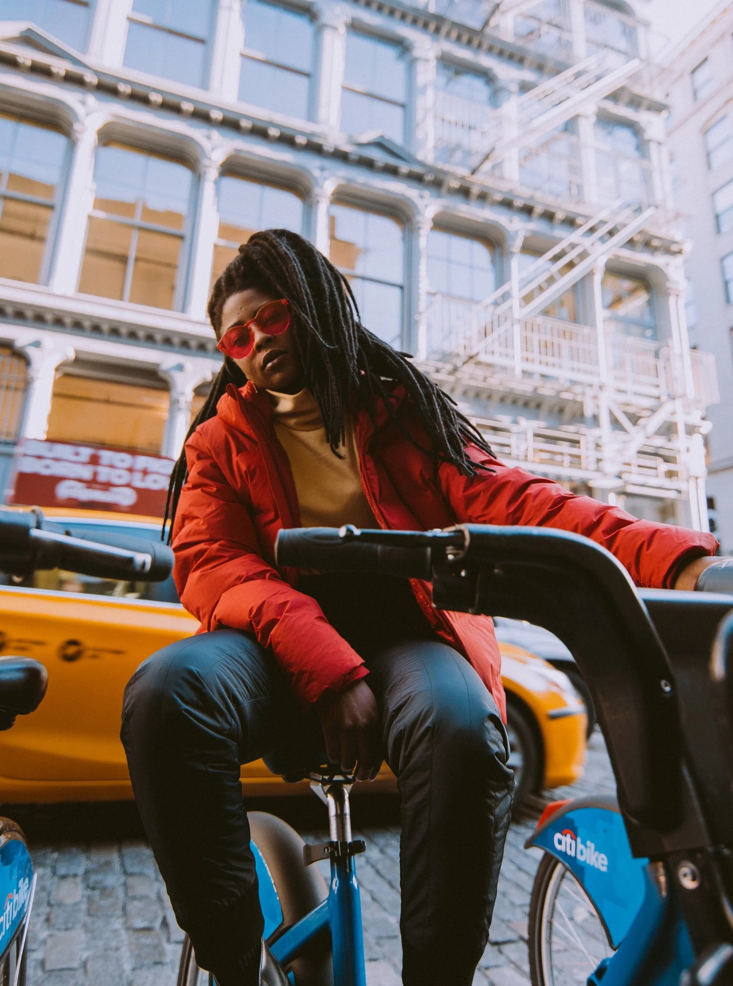 Uniqlo street style: a red coat, a bicycle, and New York City